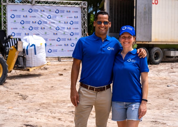Two partners from the project standing together near the beach.