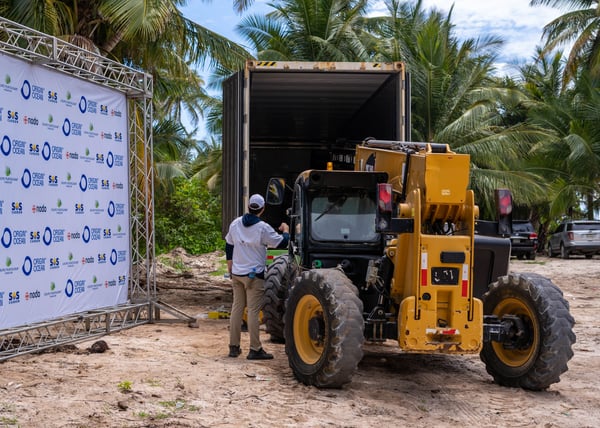 Loading harvested Sargassum onto a truck at the shore.